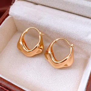 Irregular 18K gold plated hoop earrings with wavy texture in a luxury jewelry box