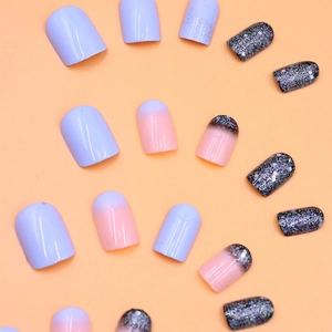 Short square press-on nails with lavender and glitter gradient design on beige background