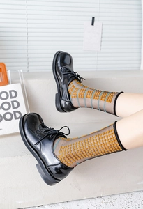 Detail of retro sheer mesh socks with yellow polka dots and blue stripes for women