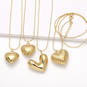 Golden heart pendant necklaces featuring four styles like smooth and floral textures