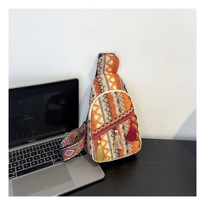 Detail view showing ethnic woven texture and colorful tassel accents on the crossbody chest bag