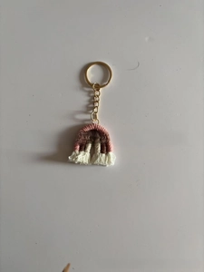 Detail of bohemian handmade rainbow keychain with colorful cotton ropes and white tassels