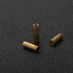 Macro view of three precision brass cylindrical pins with grooved metal details