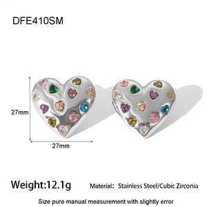 Close-up of heart-shaped stainless steel earrings with colorful cubic zirconia stones