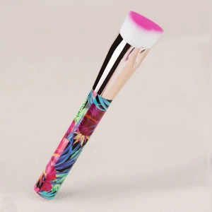 Detailed macro view of dual-tone synthetic bristles and tropical floral print brush handle