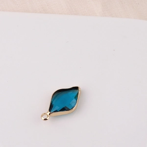 Detailed view of a blue diamond-shaped crystal pendant with gold plating for jewelry making