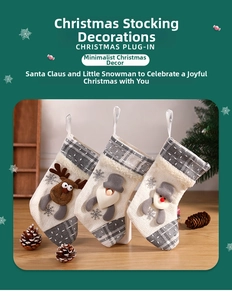 Detailed view of three knitted Christmas stockings with Santa, snowman and elk motifs