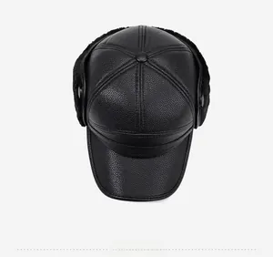 Top view of a black faux leather winter hat with earflaps and warm faux fur lining