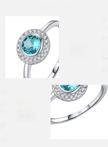 Close-up of sky blue zircon ring showing S925 sterling silver hallmark and halo setting