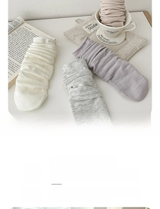 Close-up of soft breathable knit crew socks in beige grey and dusty pink colors