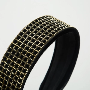Fashionable wide velvet headband featuring a black base and gold rhinestone grid patterns