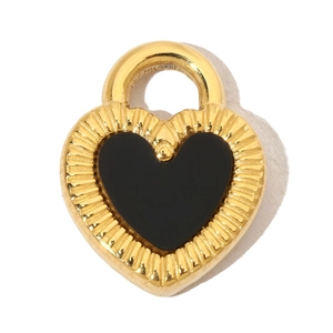 Macro shot of a heart-shaped gold-plated pendant with black enamel inlay and ribbed texture