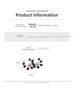 Detailed specs of hoop earrings with black glass beads and silver-grey spherical charms