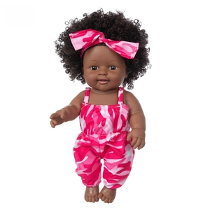 Detailed view of a 12-inch African baby doll with dark skin and pink camo romper