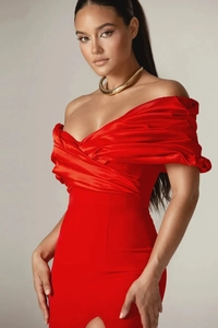 Detail of red off-shoulder evening dress featuring elegant pleated neckline and satin finish