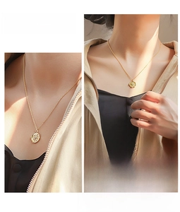 Detailed close-up of a vintage gold star coin pendant necklace on a delicate chain