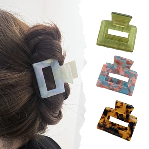 Set of four stylish acetate geometric hair claws in marble and tortoiseshell patterns