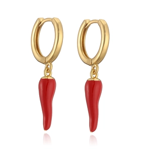 Detailed macro view of golden hoop earrings featuring glossy red chili pepper pendants