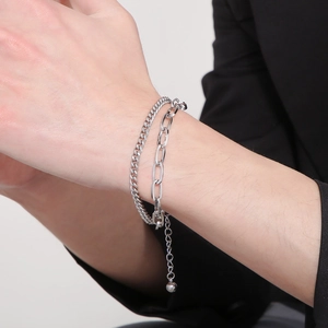 Silver double layer bracelet featuring a curb and paperclip chain for a modern look