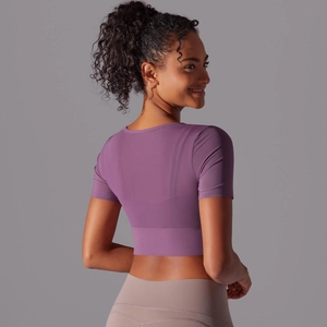 Detail view of purple slim-fit crop top for yoga featuring premium mesh texture