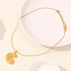 Detail of a golden chameleon pendant on a stainless steel chain with lobster clasp