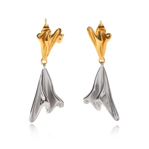 Macro detail of abstract folded two-tone stainless steel earrings in gold and silver
