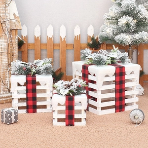 Three-piece wooden Christmas gift box set with white slats, plaid bows, and faux snow