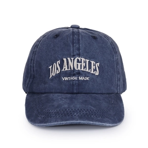Detail of Los Angeles embroidery on vintage washed navy blue cotton baseball cap