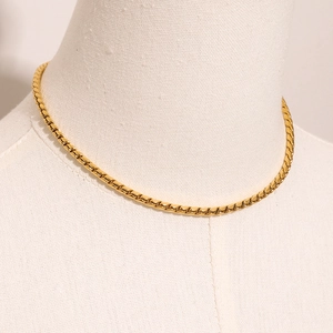 Detail of 18K gold-plated stainless steel 3mm flat oval chain necklace on mannequin