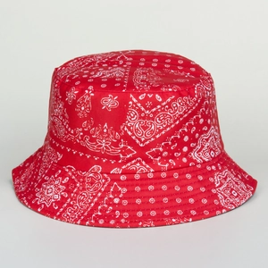 Close-up of red bucket hat with white paisley print, focus on breathable canvas fabric