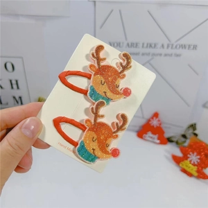 Pair of festive reindeer hair clips with glitter details and red snowman accents