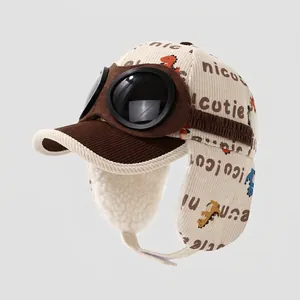 Kids vintage pilot hat with dinosaur print, corduroy earflaps and goggles in beige