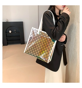 Detailed holographic heart pattern on large PU leather tote bag shown in use