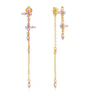 Macro view of butterfly earrings with pink zircon stones and long gold tassels