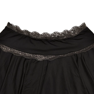 Detail of black skirt featuring delicate grey lace trim and soft fabric texture