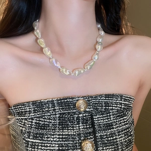 Baroque style necklace with irregular pearls and iridescent luster worn on neck