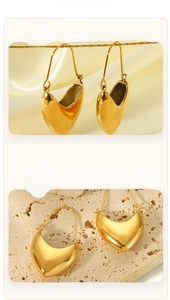 Macro detail of 18K gold plated teardrop earrings with polished mirror finish on silk