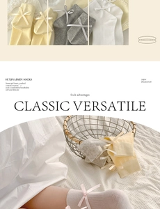 Detail of sweet cotton socks with satin ribbon bows in cream and grey colors