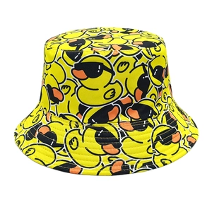 Detailed close-up of yellow bucket hat with cartoon duck prints and fine edge stitching