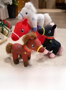 Group of colorful stuffed horse toys with floral embroidery on soft plush carpet