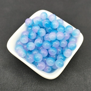 Close-up of 8mm blue and purple gradient glass beads in a square white tray