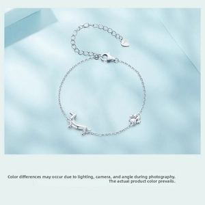 Close-up of S925 sterling silver dachshund puppy bracelet with cutout paw charm