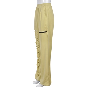 Detailed khaki cargo pants showing lateral hollow cutouts and metal zipper pocket design