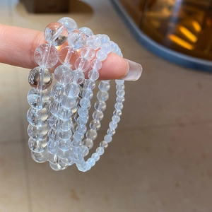 Close-up of three clear crystal beaded bracelets in varying bead sizes for women