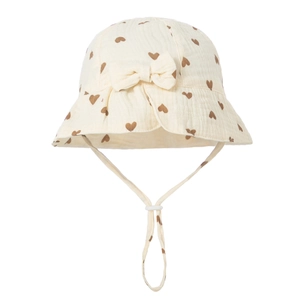 Detail view of baby cotton sun hat with brown heart prints and a fabric bow decoration