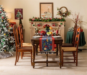 Detailed close-up of festive jacquard table runner with tassels and Christmas patterns