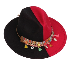 Detail of red and black felt fedora featuring ethnic band with shells and tassels