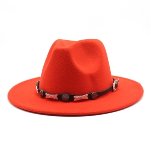 Detailed close-up of a red jazz fedora featuring a black leather band with silver metal studs