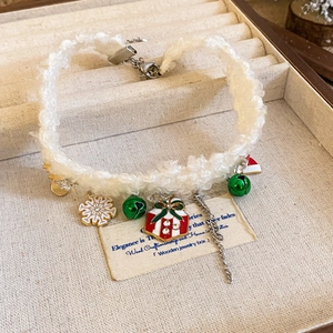 Christmas plush choker with snowflake and bell charms in a wooden jewelry box