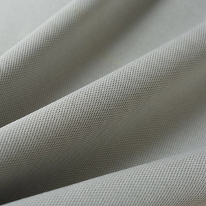 Macro shot showing high-quality gray knitted fabric texture with detailed mesh weave pattern